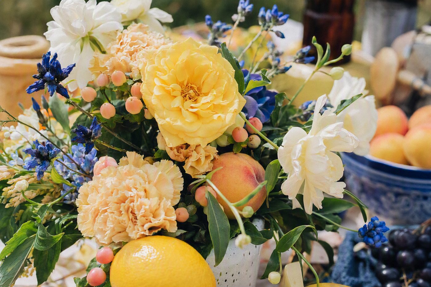 Saison: a joyful mix of yellow, peach, blue and green seasonal blooms with fruit